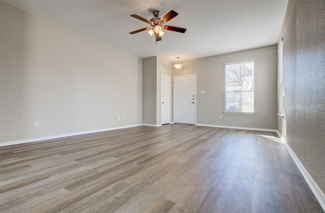 spare room with ceiling fan and light hardwood / wood-style floors