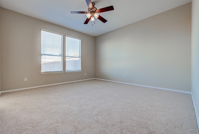 carpeted spare room with ceiling fan