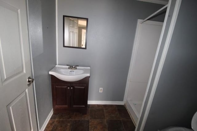 bathroom featuring vanity and a shower