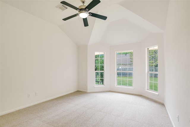 carpeted spare room featuring ceiling fan and vaulted ceiling