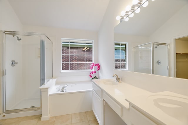 bathroom with vaulted ceiling, separate shower and tub, tile patterned floors, and vanity