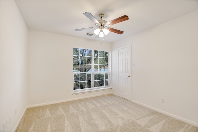 carpeted empty room featuring ceiling fan