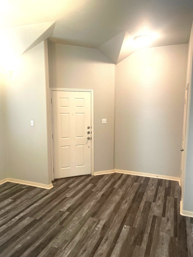 foyer featuring lofted ceiling and dark hardwood / wood-style floors