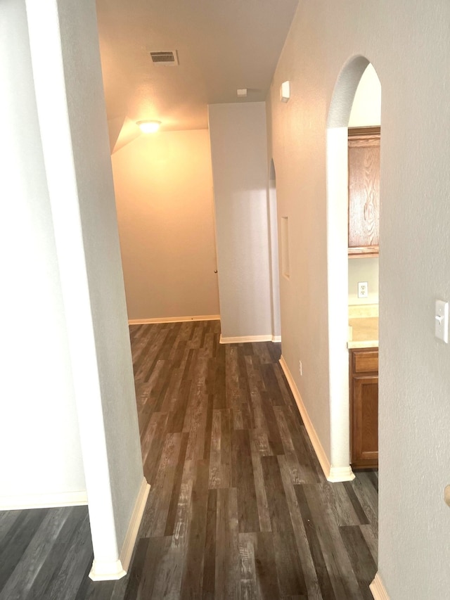 hallway with dark hardwood / wood-style flooring