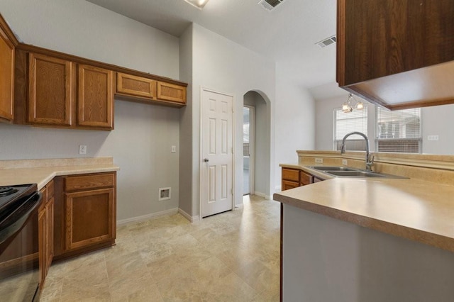 kitchen featuring black range with electric stovetop and sink