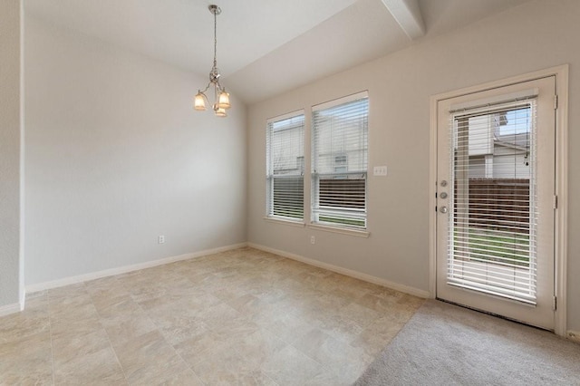 spare room with an inviting chandelier and vaulted ceiling