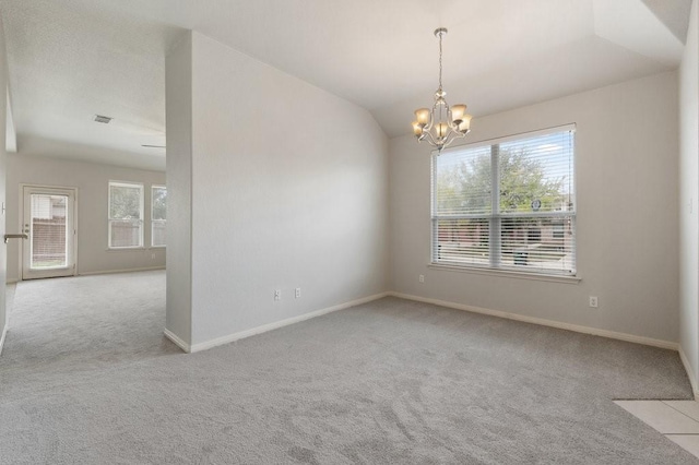 empty room with light carpet, a notable chandelier, lofted ceiling, and a healthy amount of sunlight