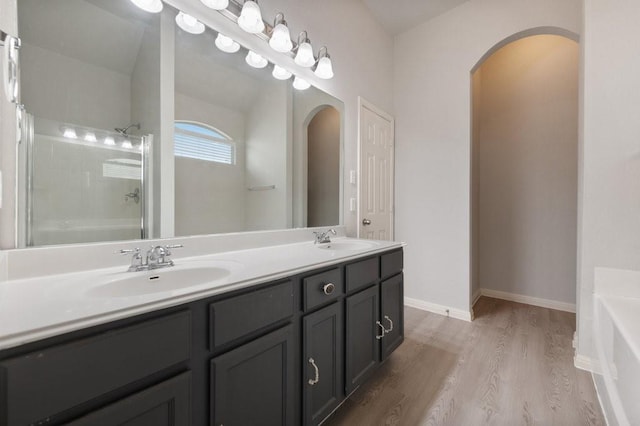 bathroom featuring independent shower and bath, vanity, and hardwood / wood-style floors