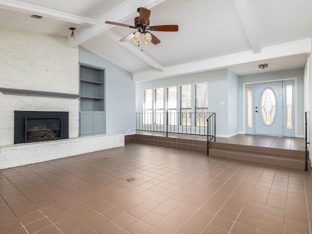 unfurnished living room featuring vaulted ceiling with beams, a stone fireplace, visible vents, built in features, and tile patterned floors