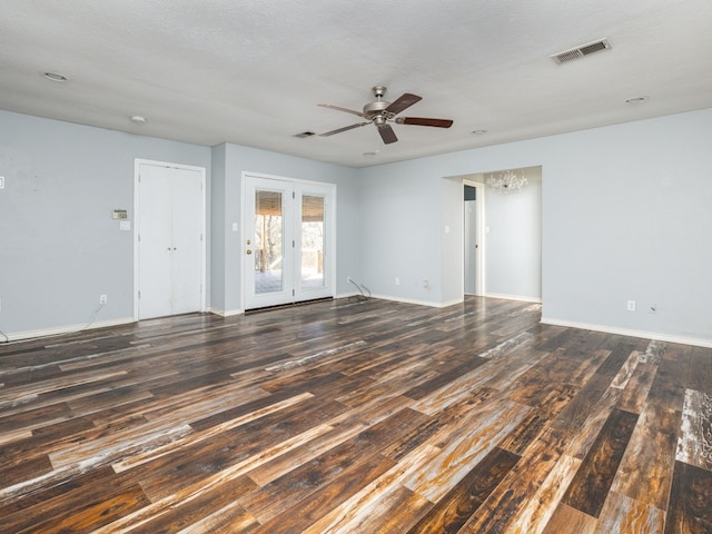 unfurnished room with wood finished floors, visible vents, and baseboards