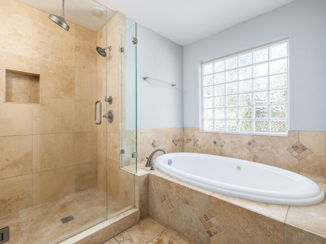 bathroom with a shower stall and a bath