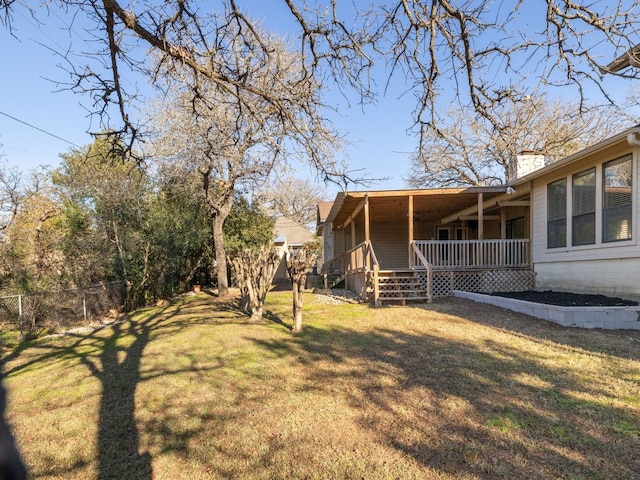 view of yard with a porch and fence