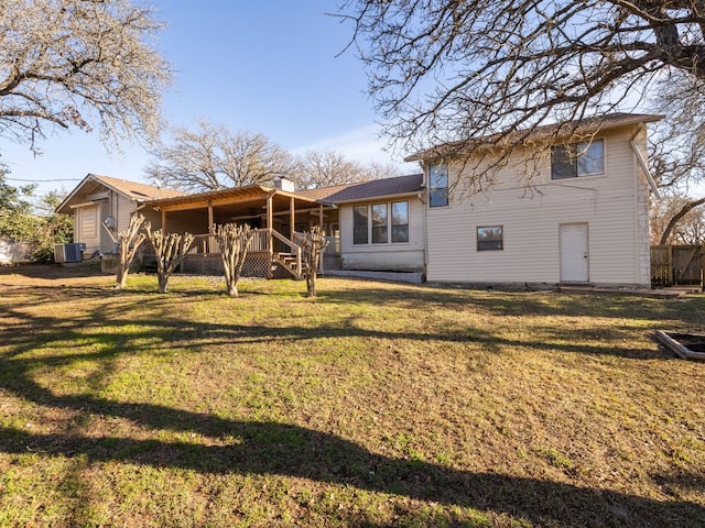 back of house with a yard and central AC unit