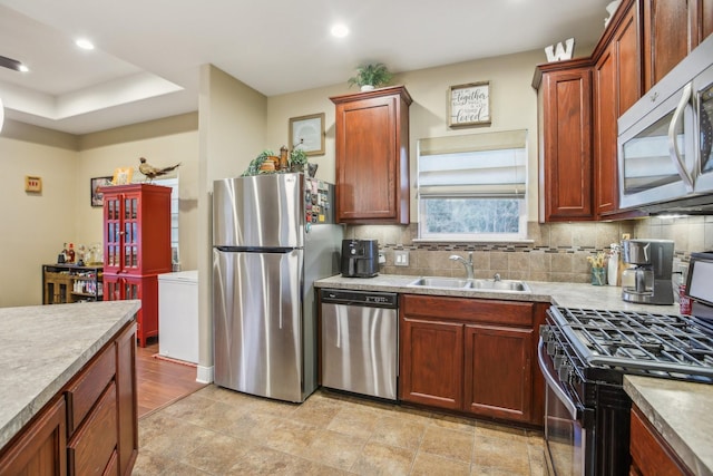 kitchen with stainless steel appliances, tasteful backsplash, and sink