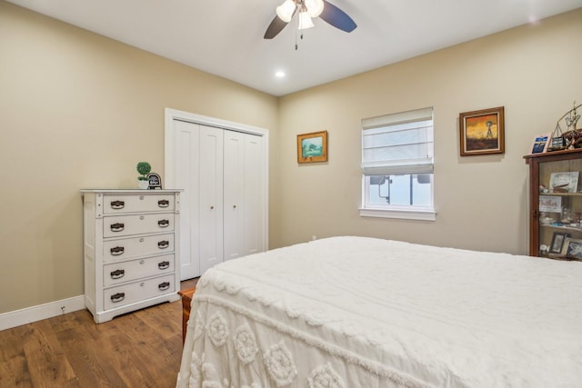 bedroom featuring hardwood / wood-style flooring, ceiling fan, and a closet