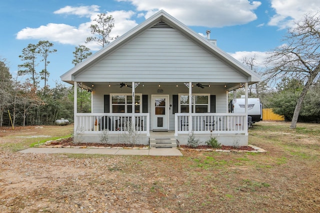 view of front of property featuring a porch, a front yard, and central AC unit