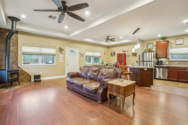 bungalow featuring ceiling fan, covered porch, and a front lawn