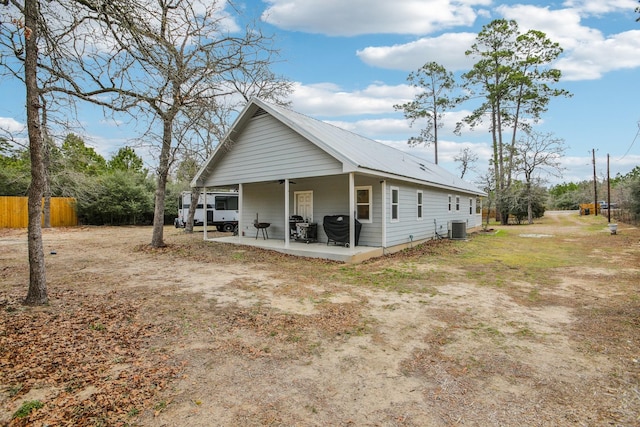 view of side of property featuring a patio and cooling unit