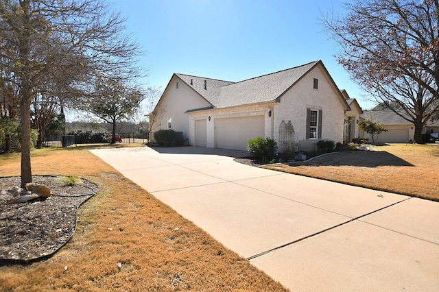 view of side of home featuring a garage and a yard