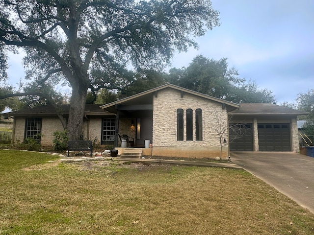 ranch-style house featuring a garage and a front lawn