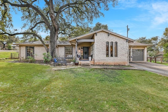 view of front of property with a garage and a front yard