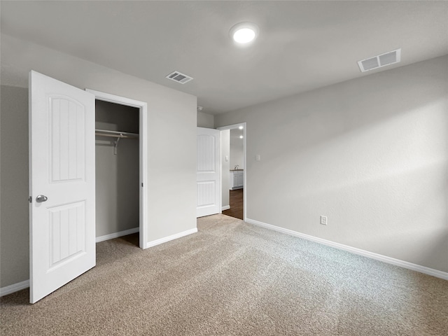 unfurnished bedroom with carpet and a closet