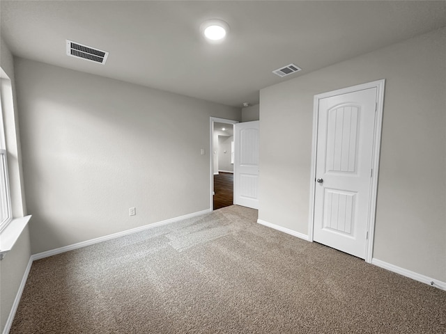 unfurnished bedroom featuring carpet and a closet