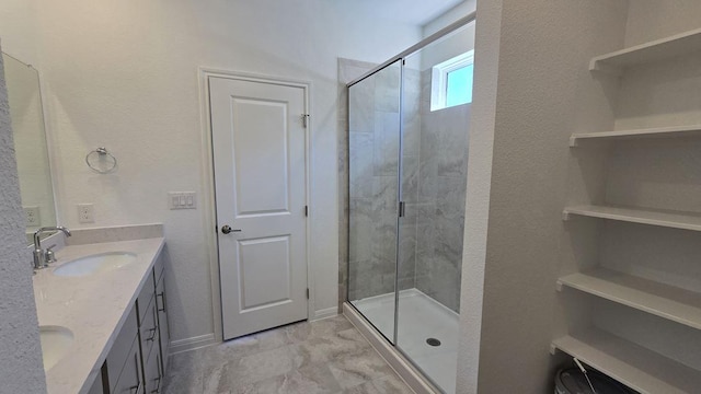 full bath featuring a shower stall, double vanity, and a sink