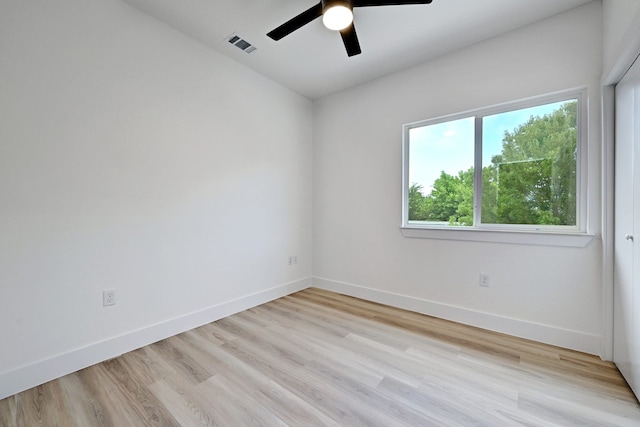 spare room featuring light hardwood / wood-style floors and ceiling fan