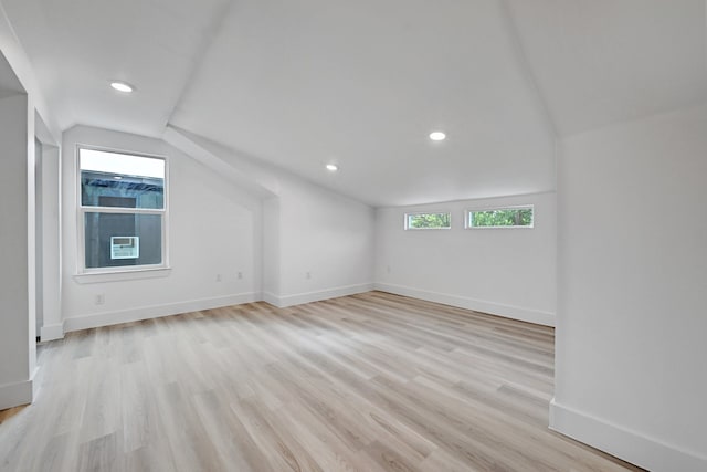 additional living space with lofted ceiling and light hardwood / wood-style floors