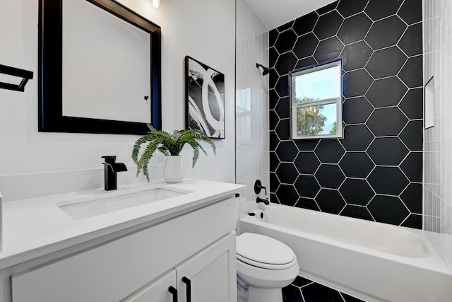 full bathroom with vanity, tiled shower / bath combo, tile patterned floors, and toilet