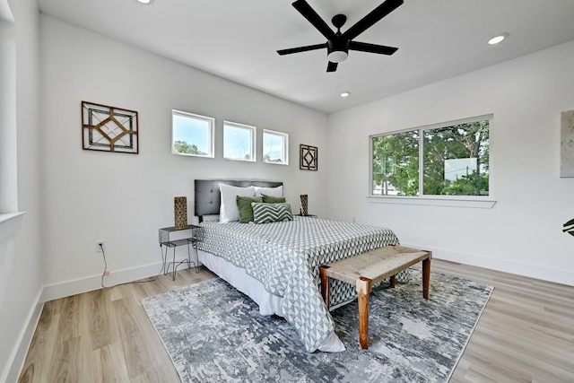 bedroom with ceiling fan and light hardwood / wood-style floors