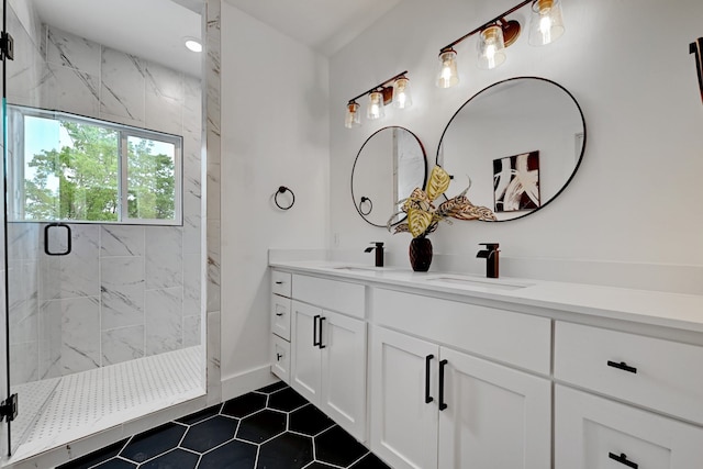 bathroom with a shower with door and vanity