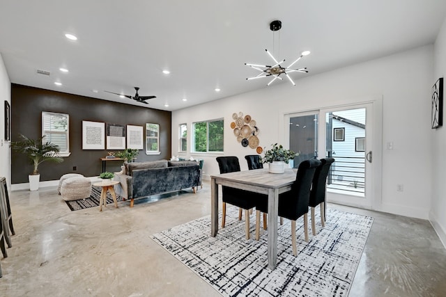 dining space featuring ceiling fan with notable chandelier