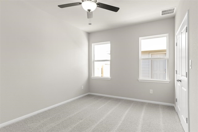 carpeted spare room with ceiling fan