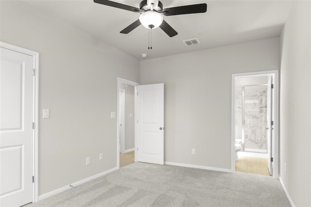 unfurnished bedroom featuring ceiling fan, light colored carpet, and ensuite bathroom