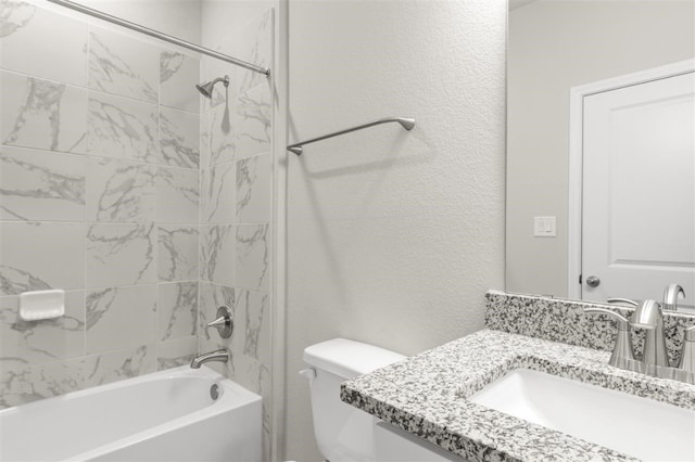 full bathroom featuring vanity, toilet, and tiled shower / bath combo