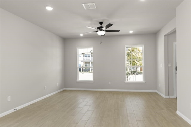 spare room featuring ceiling fan and light hardwood / wood-style flooring