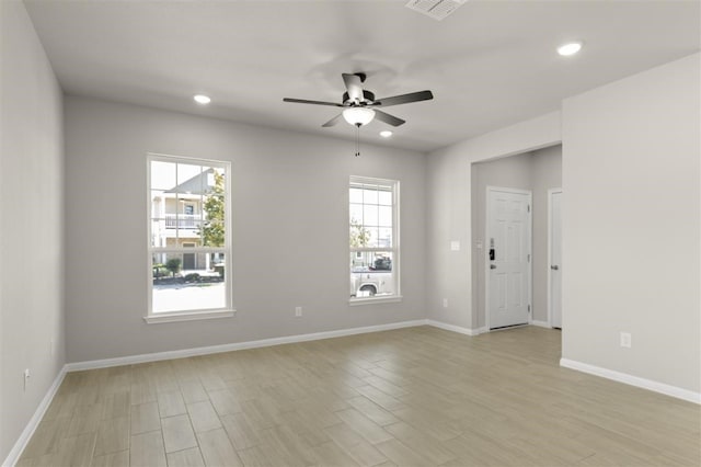 unfurnished room featuring light hardwood / wood-style flooring, plenty of natural light, and ceiling fan