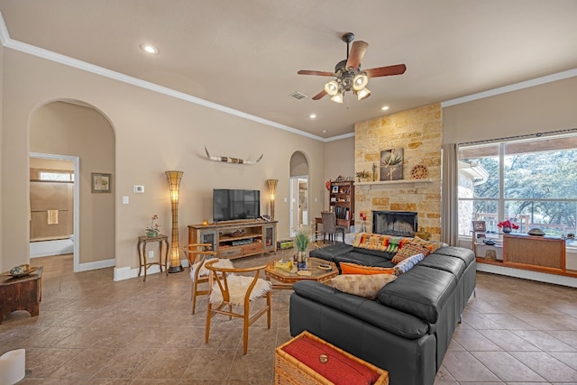 living room with ornamental molding, light tile patterned floors, ceiling fan, and a fireplace