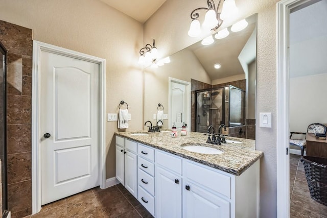 bathroom featuring lofted ceiling, tile patterned floors, an enclosed shower, vanity, and a notable chandelier