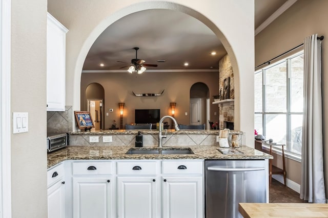 615 Mountain Crest Dr, Wimberley, TX 78676 - kitchen with a sink, dishwasher, ceiling fan, backsplash, and stone countertops