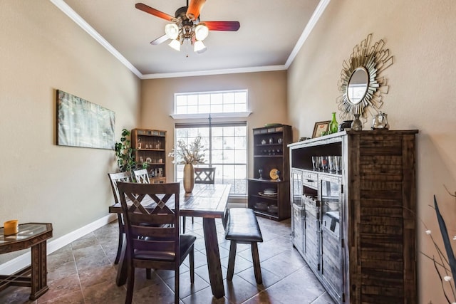 tiled dining area with ceiling fan and ornamental molding