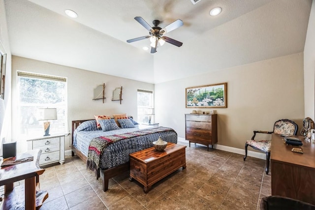 bedroom featuring multiple windows, lofted ceiling, and ceiling fan