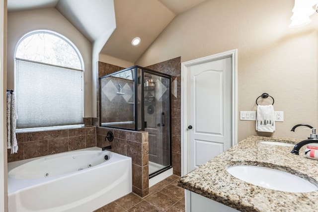 bathroom with plus walk in shower, lofted ceiling, vanity, and tile patterned floors