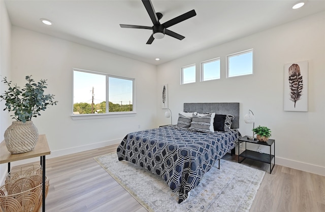 bedroom with a ceiling fan, recessed lighting, baseboards, and wood finished floors