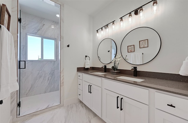 full bath featuring double vanity, marble finish floor, a marble finish shower, and a sink