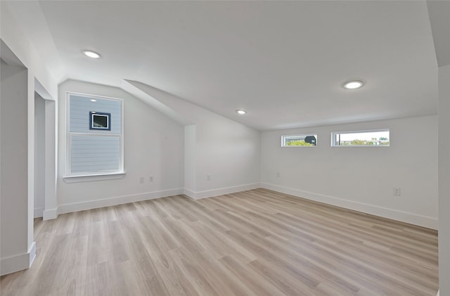 bonus room featuring lofted ceiling, baseboards, light wood finished floors, and recessed lighting