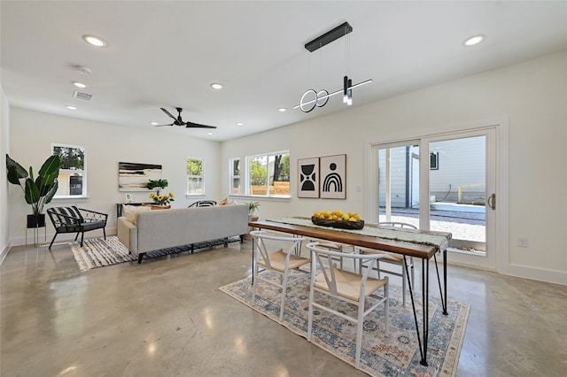 dining room with baseboards, visible vents, concrete flooring, and recessed lighting