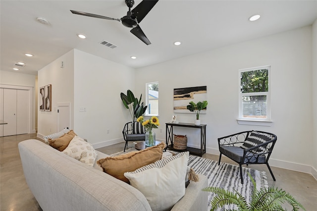 living room with baseboards, visible vents, a ceiling fan, and recessed lighting